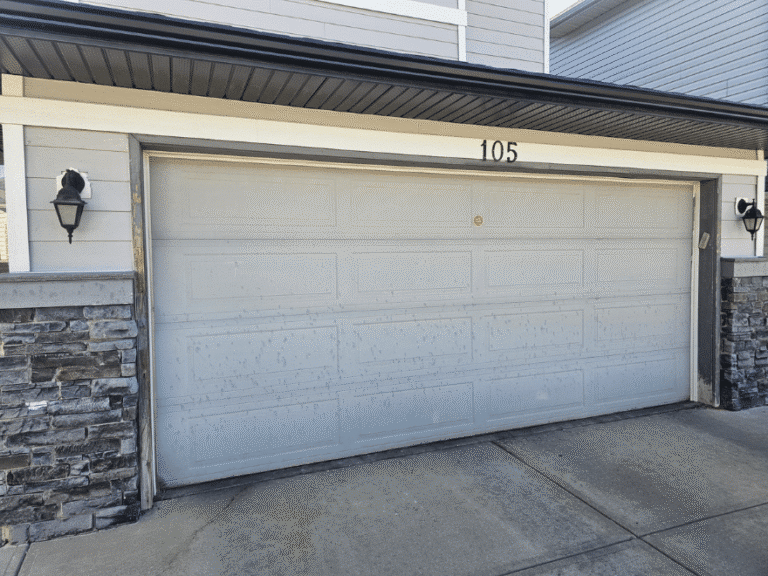 White double garage door with a raised-panel design.