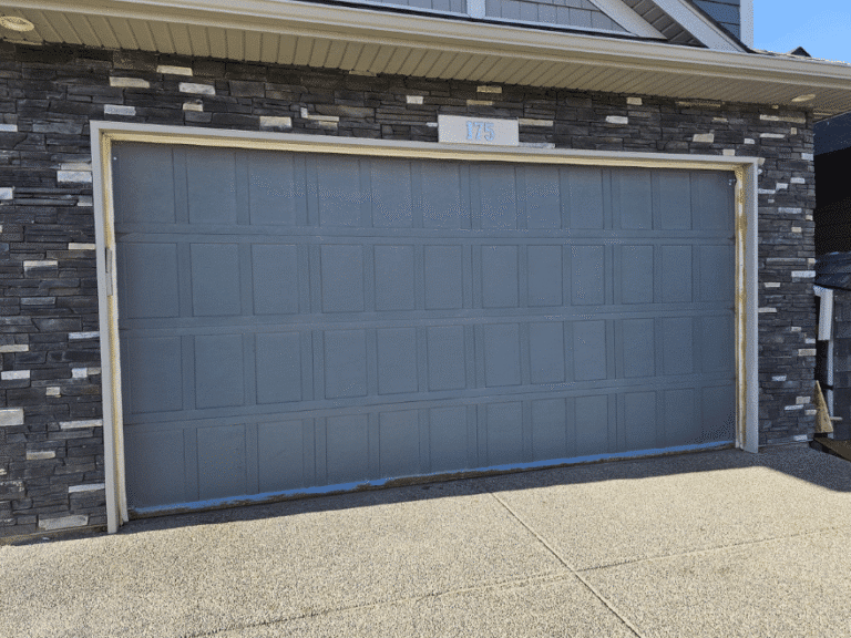 Gray double garage door with recessed panel design.