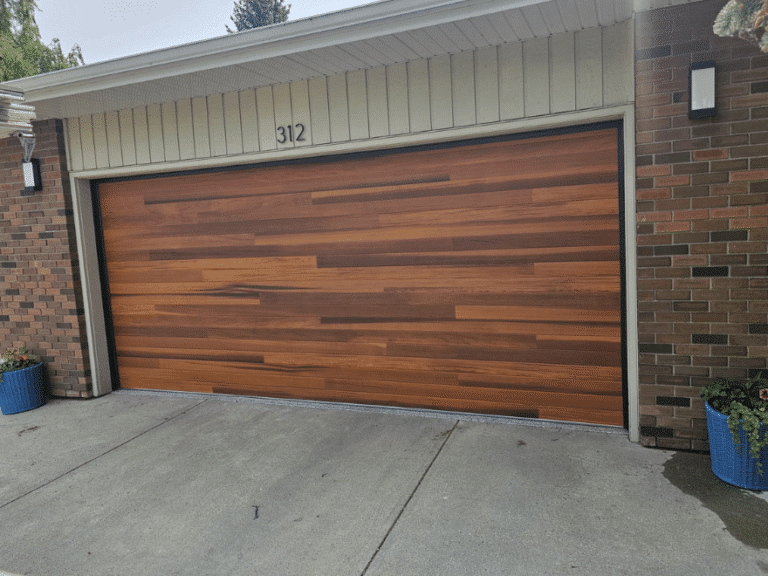 Modern double garage door with a horizontal wood-look finish.
